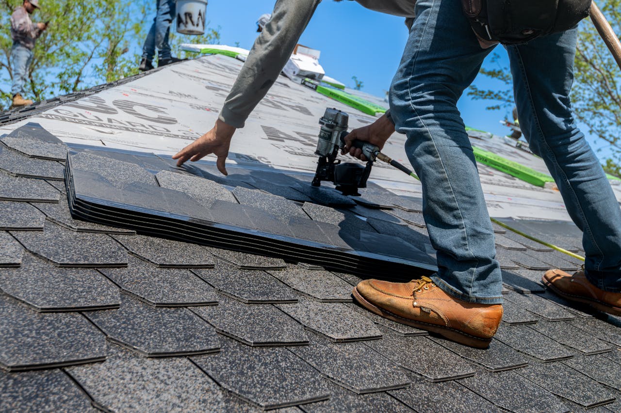 Professional roofer installing shingles on a residential roof in Oshawa Ontario